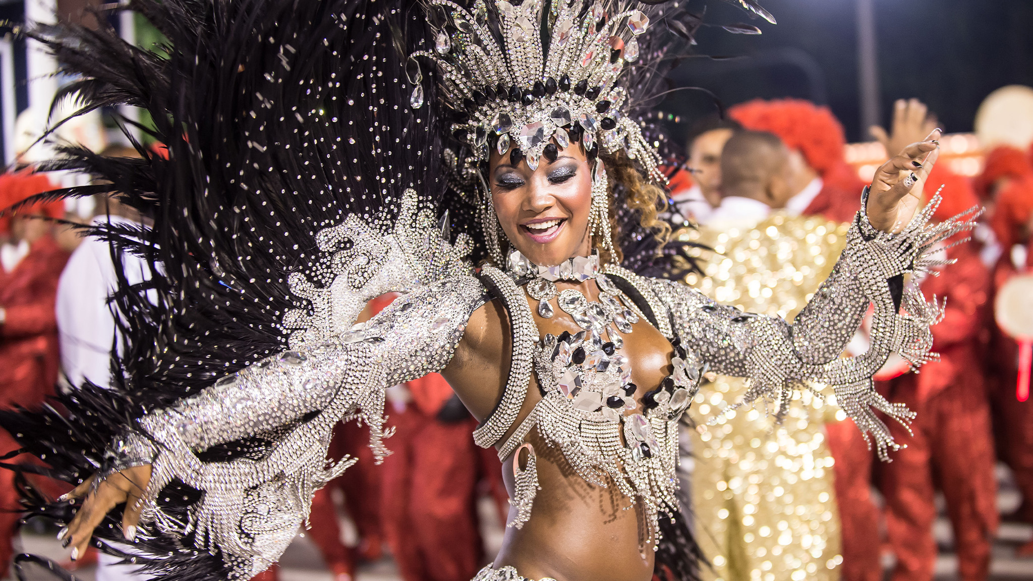 A samba dancer in a dazzling silver crystal and feather costume at Rio Carnival
